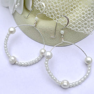Freshwater pearl and cream colored glass beads hoop earrings.