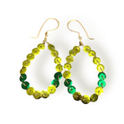Green and yellow beaded hoop earrings on a white background
