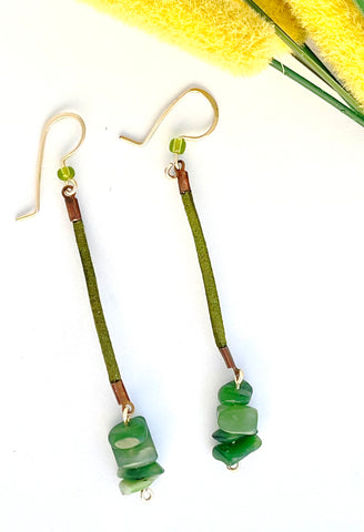 Dangle earrings made with green cord and green jade beads.  Jade stone used for energy healing.