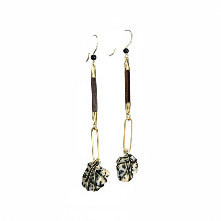 Pair of earrings with gold and black design on a white background