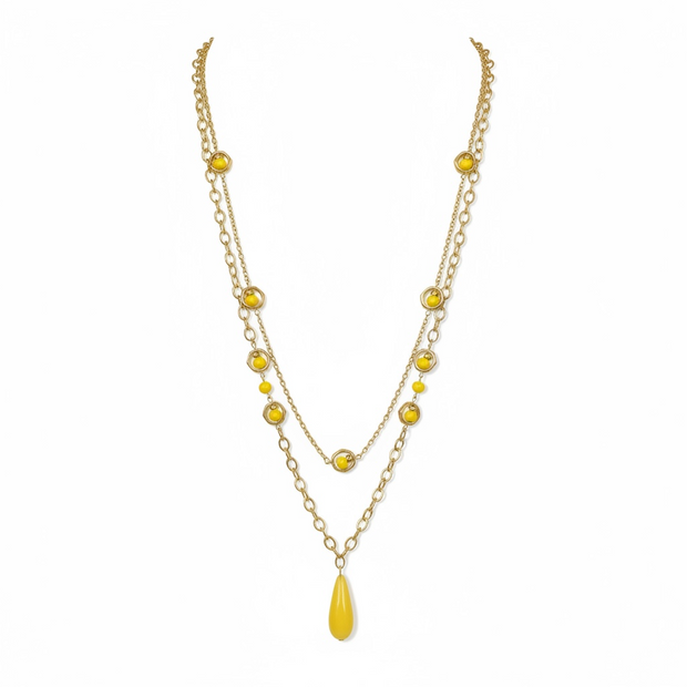 Gold necklace with yellow beads on a white background