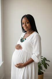 pregnant female with turquoise black and white necklace