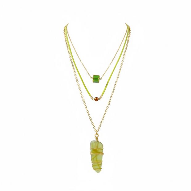 Two necklaces with green  glass and gemstones on a white background