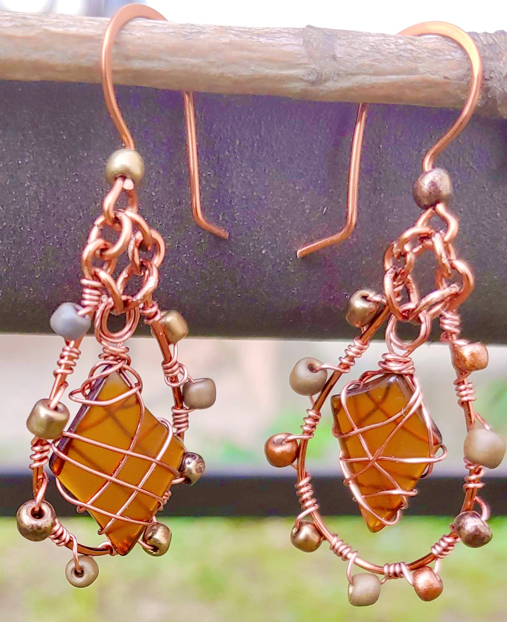 Copper dangle earrings with recycled glass and beading.