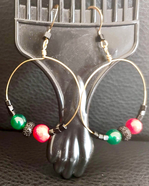 Angela Davis Gold tone hoop earrings with red, green, and black beads