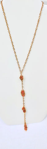 Long Necklace with sun stones wire wrapped in gold tone wire.  